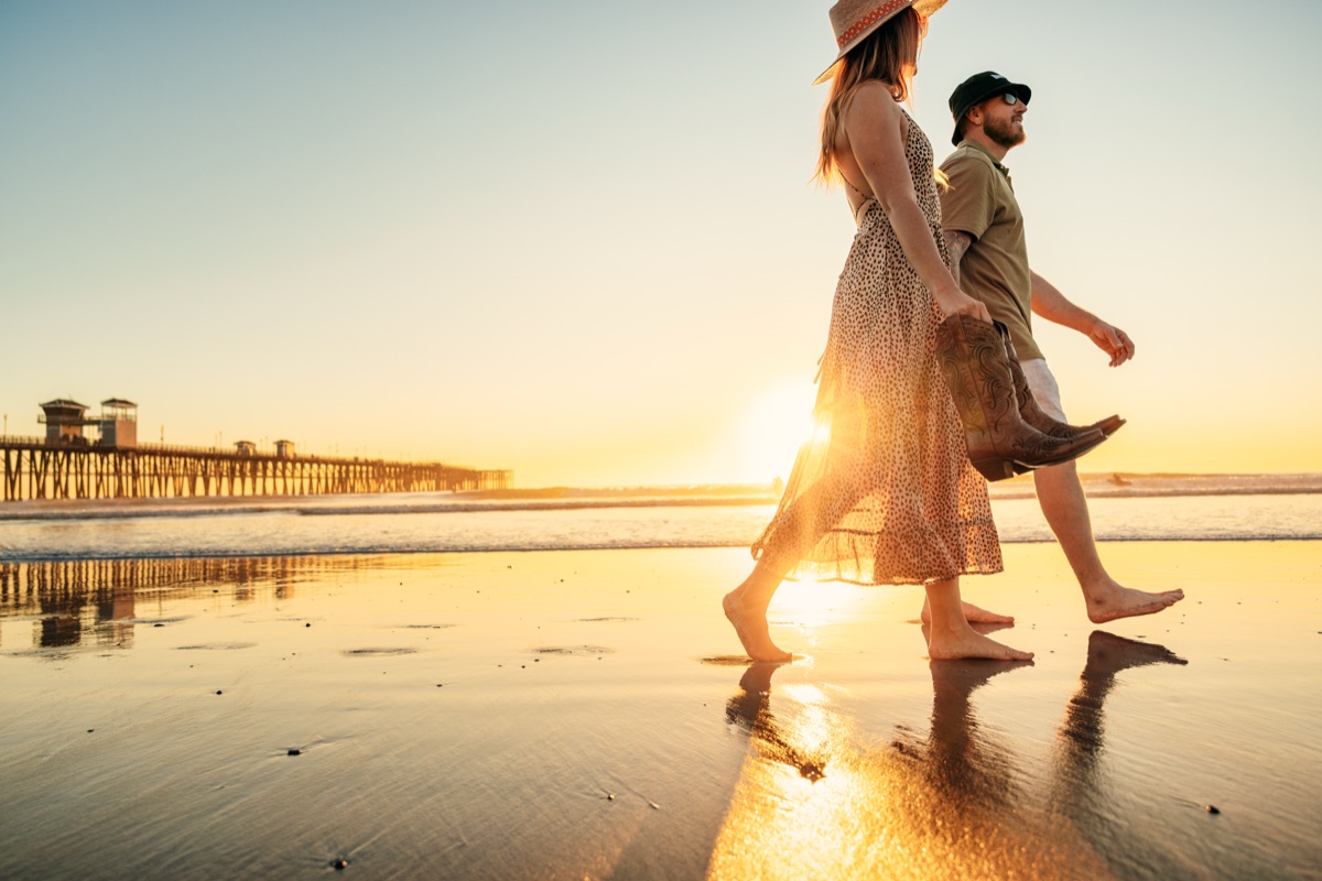 Couple walking at sunset near Oceanside Pier